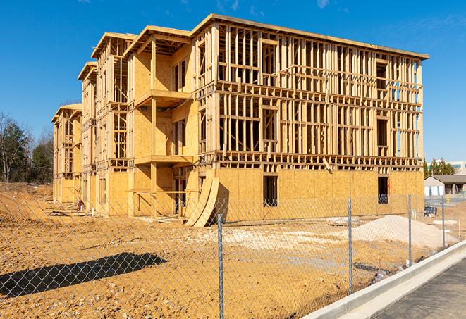 a job site enclosed by temporary chain link fences, ensuring safety for workers and pedestrians in Emeryville