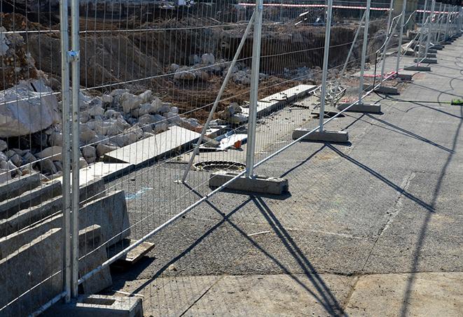 a stack of temporary barrier panels, preventing access to a restricted area